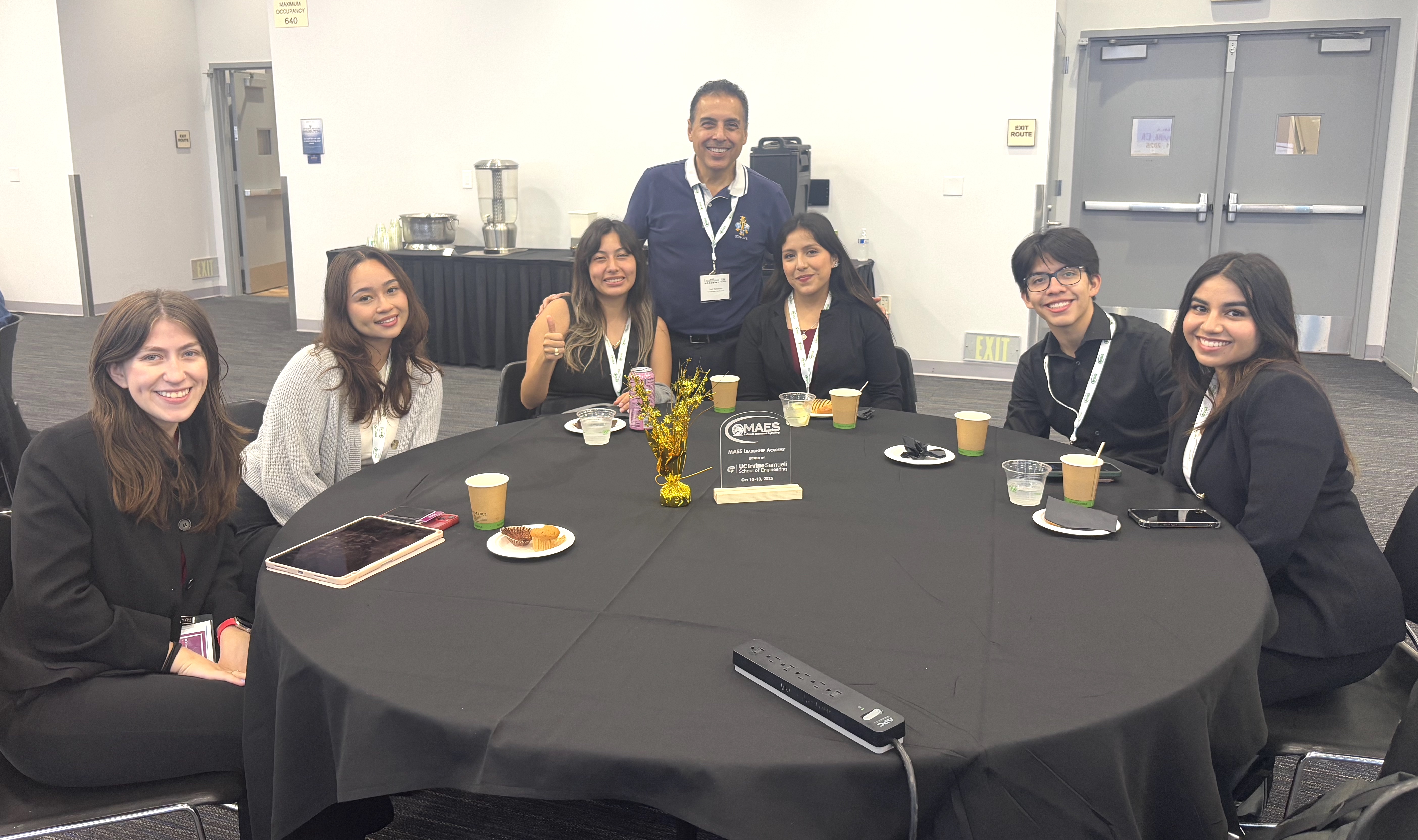 José Hernández (standing) with students at the conference.