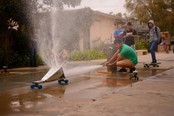 Students on race their carts using a pressurized water tank as propellant