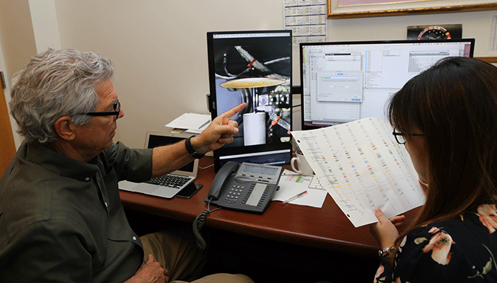 Dunn-Rankin and Chien watch via a live video stream as their experiment runs aboard the International Space Station