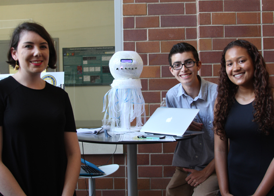 Lauren Martini, Cristian Meija and Kaelin Marshall display Jellyfish Jamz, an Internet radio box, at the ASPIRE/INSPIRE final presentation event