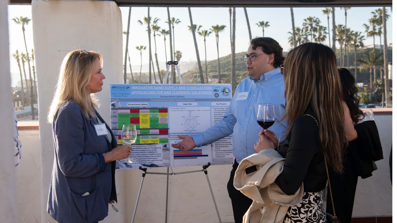 UCI grad student Jacob Samson (right) presents his solution to attendees of the Resilient Shores reception in San Clemente. (Steve Zylius/UCI) UCI grad student Jacob Samson (right) presents his solution to attendees of the Resilient Shores reception in San Clemente. (Steve Zylius/UCI)