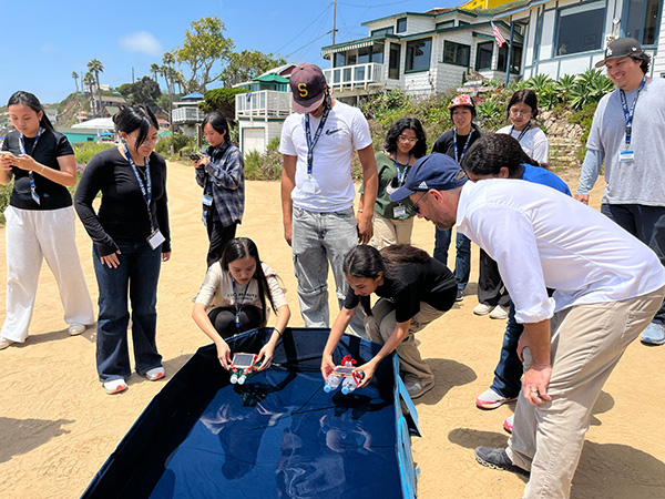 The students test and race their self-powered solar boats.