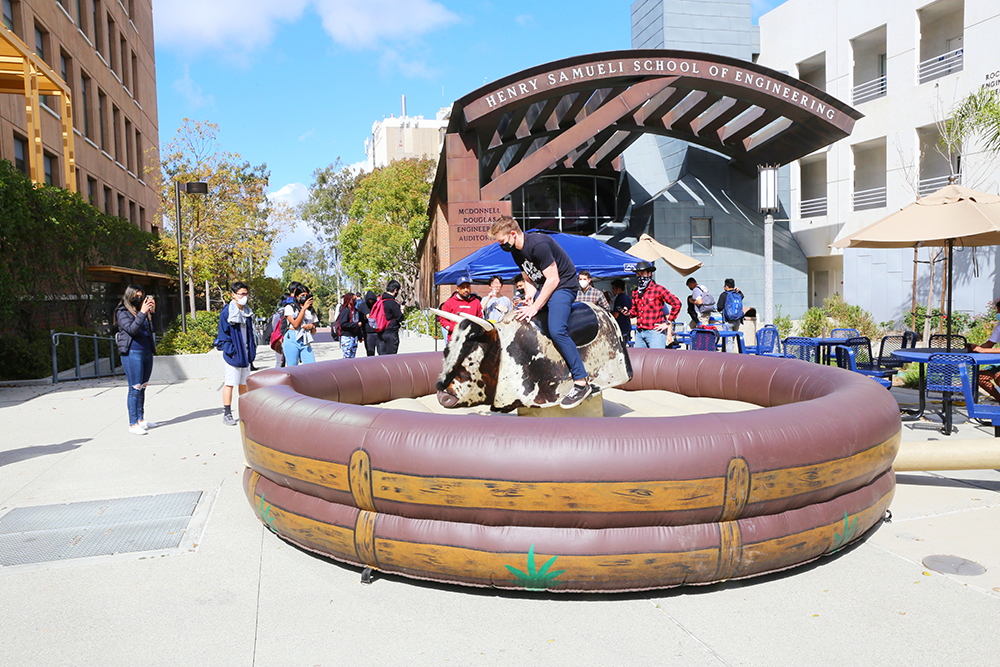 Students took turns riding a mechanical bull at the E-Week Kickoff Fair.