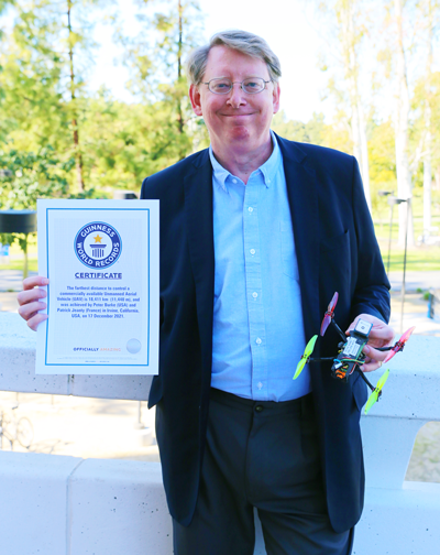 Peter Burke shows off the small drone he used to win the Guinness World Record for “the farthest distance to control a commercially available Unmanned Aerial Vehicle (UAV).”