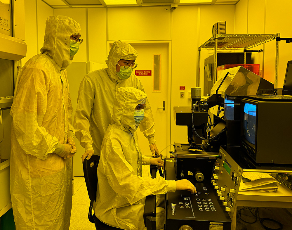 Students work on an aligner for photolithography in UCI’s clean room.