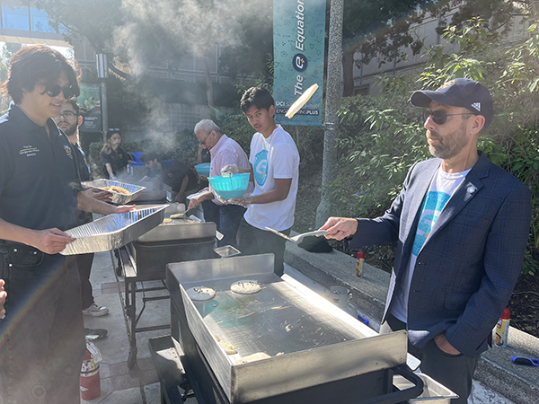 Dean Magnus Egerstedt flips pancakes for engineering students at the E-Week Dean’s Breakfast.