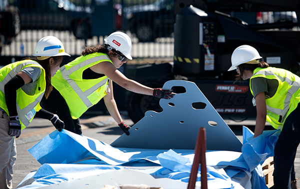 Female students building the home at the OC Sustainability Decathlon