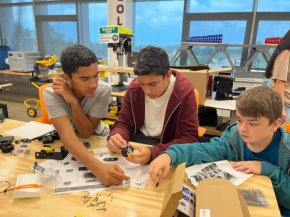 Student work on a robot together on Engineering Ignition Day