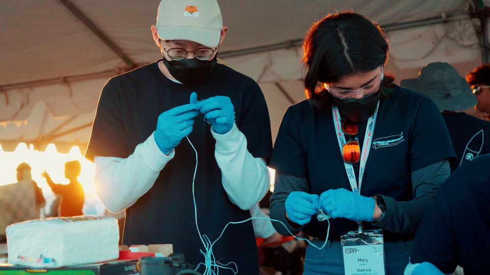 UCI Rocket Project Solids Avionics Software Lead Sean Liem (left) and Avionics Hardware Lead Mary Ajemyan (right) prepare ejection charges for the rocket’s parachutes. UCI Rocket Project Solids Avionics Software Lead Sean Liem (left) and Avionics Hardware Lead Mary Ajemyan (right) prepare ejection charges for the rocket’s parachutes.