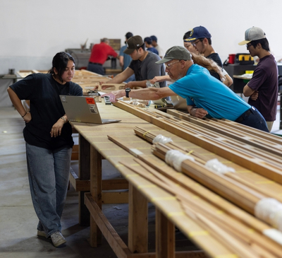 Project manager and mechanical engineering student Stuti Patel reviews plans with Experimental Aircraft Association member Rhon Williams. Photo: Flying Leathernecks Heritage Foundation Project manager and mechanical engineering student Stuti Patel reviews plans with Experimental Aircraft Association member Rhon Williams. Photo: Flying Leathernecks Heritage Foundation