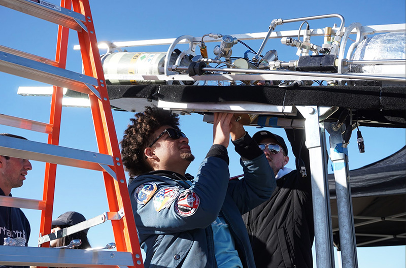 Quincy Barnes (middle) helps set up the methalox rocket Quincy Barnes (middle) helps set up the methalox rocket