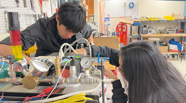 Rachael Koo (right) with Anthony Chin (left) working on HyperXite