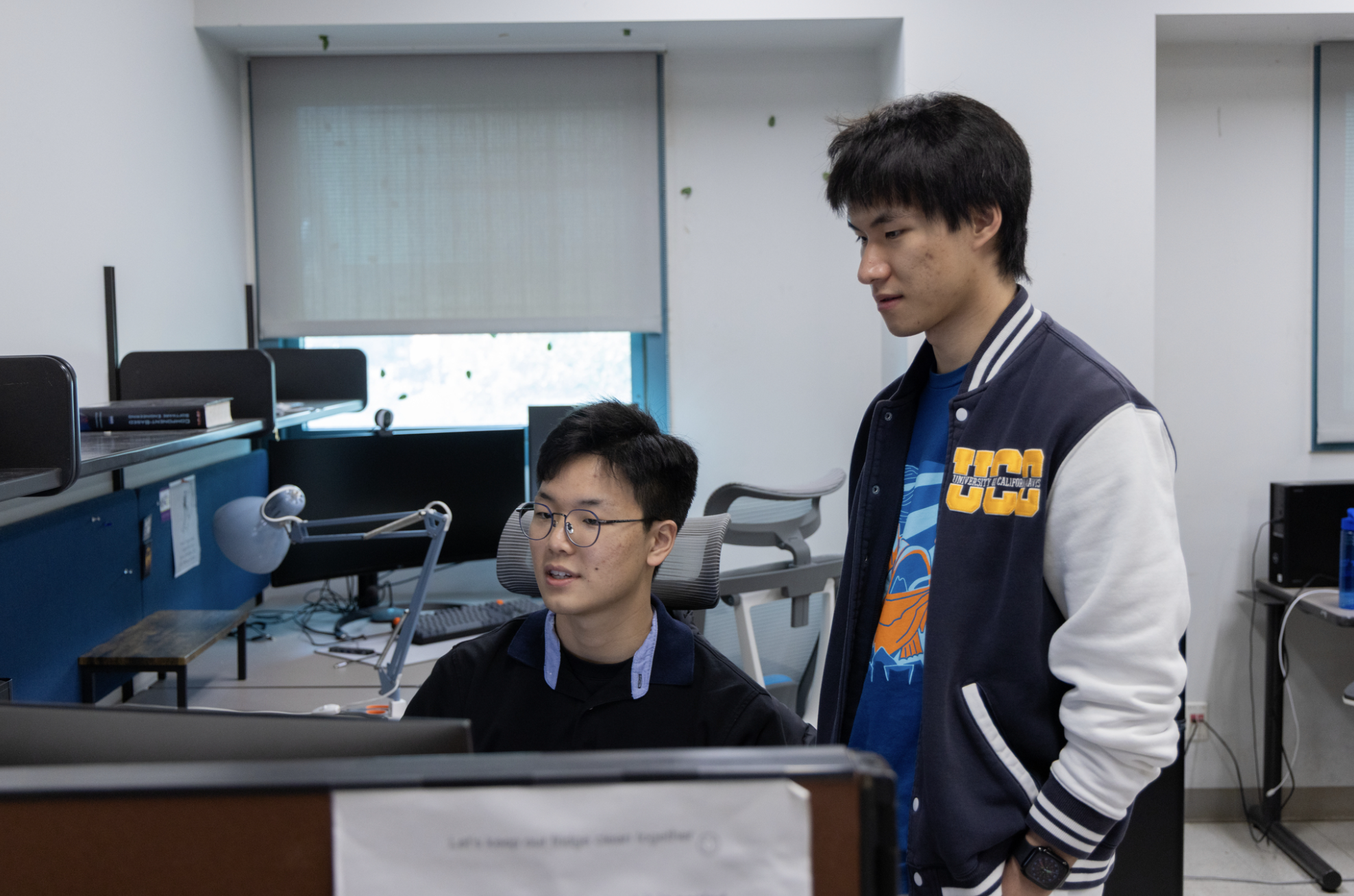 Kim, left, and Zhu work on teaching a computer vision model to recognize and analyze certain hand motions. (Elena Troncoso/UC Davis)