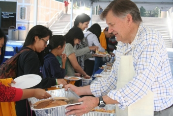 John LaRue, associate dean for undergraduate affairs, passes out pancakes at last year's Dean's Breakfast. 